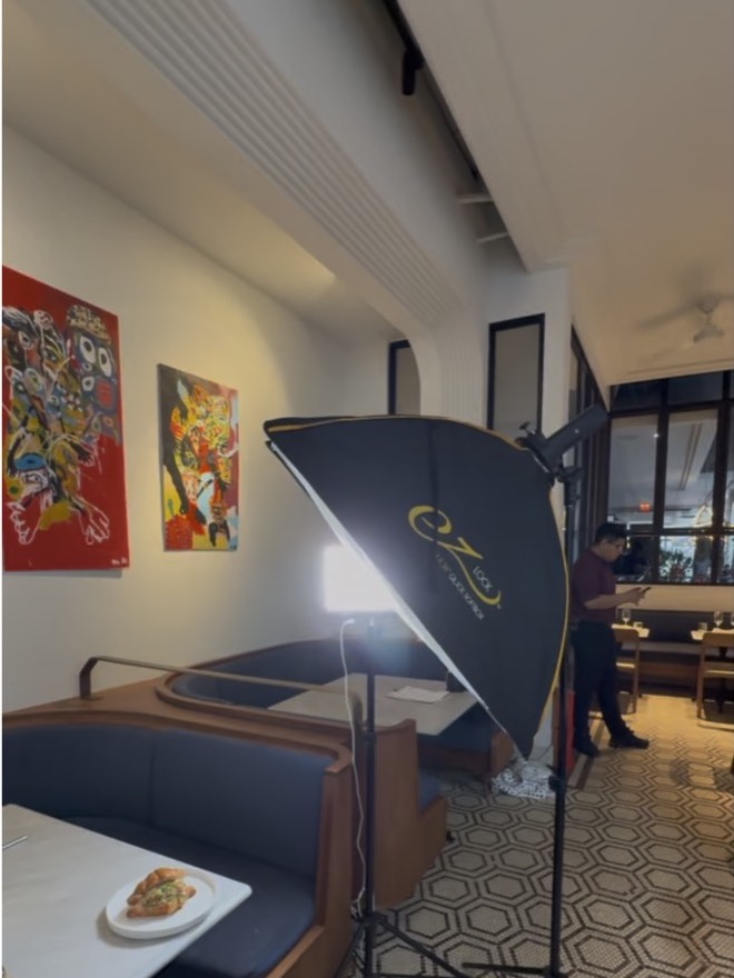 Behind the scenes: softbox lighting set up inside a restaurant dining room